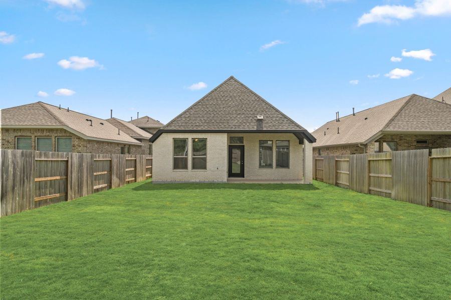 Large fenced backyard and rear exterior with room for outdoor living, play and entertaining.