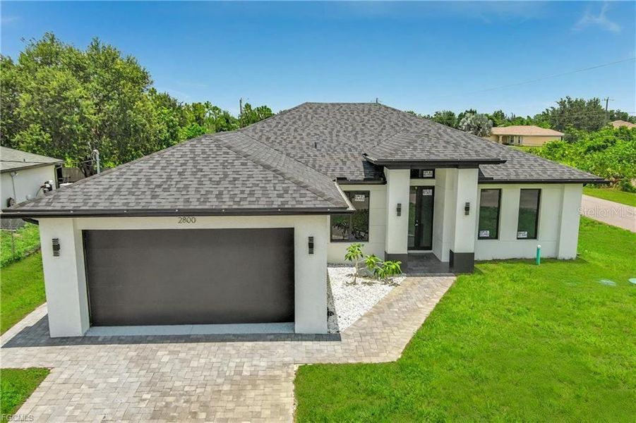 Front exterior of a new home in , Lehigh Acres, FL, highlighting curb appeal (Image 1). Front exterior of a new home in , Lehigh Acres, FL, highlighting curb appeal (Image 1).