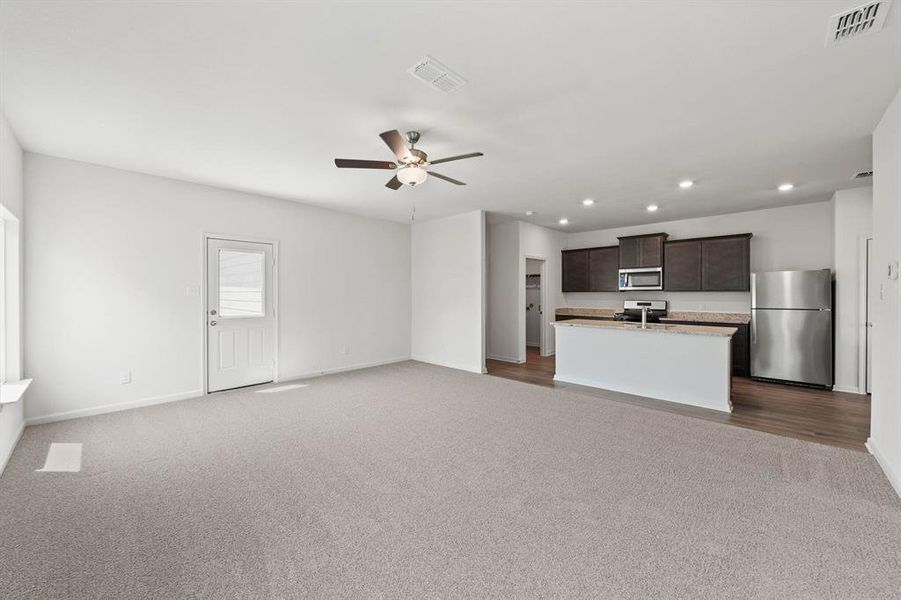 Living room with ceiling fan and wood-style floors