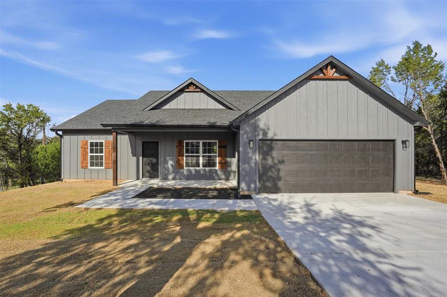 Front exterior of a new home in , Granbury, TX, highlighting curb appeal (Image 1).
