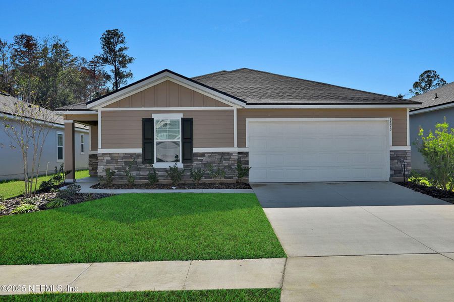Front exterior of a new home in Wilford Oaks, Orange Park, FL, highlighting curb appeal (Image 1).