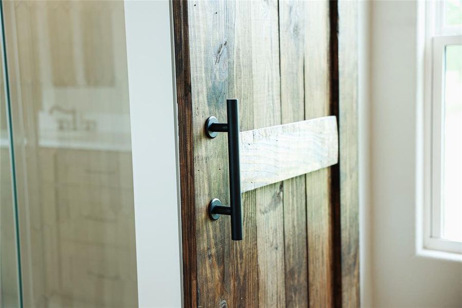 Reclaimed wood-style barn door with matte black hardware