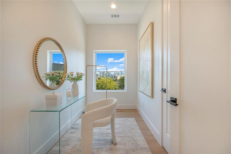 Doorway to outside featuring wood finished floors and baseboards Doorway to outside featuring wood finished floors and baseboards
