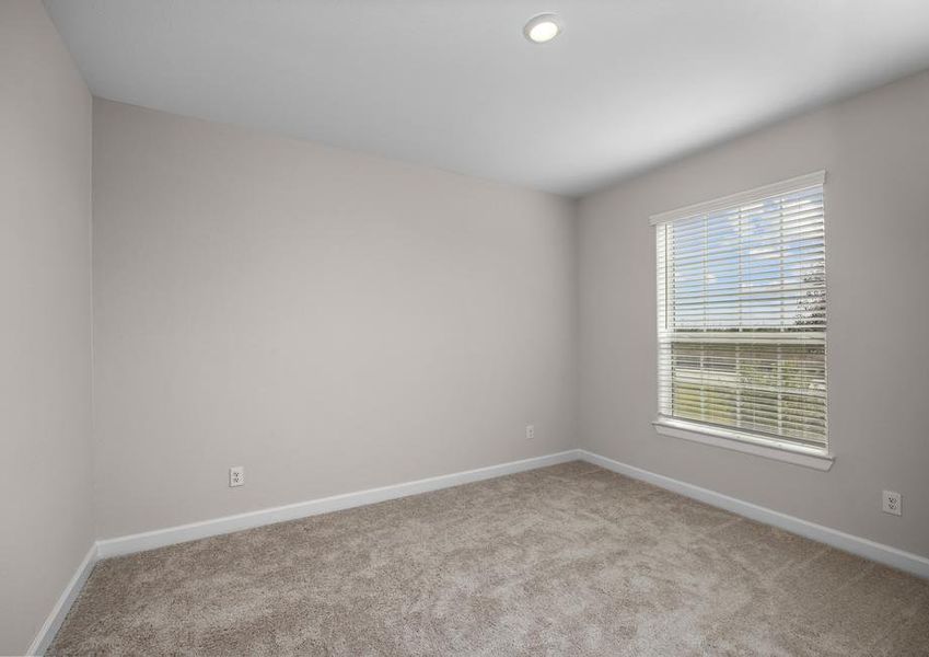 Secondary bedroom with carpet