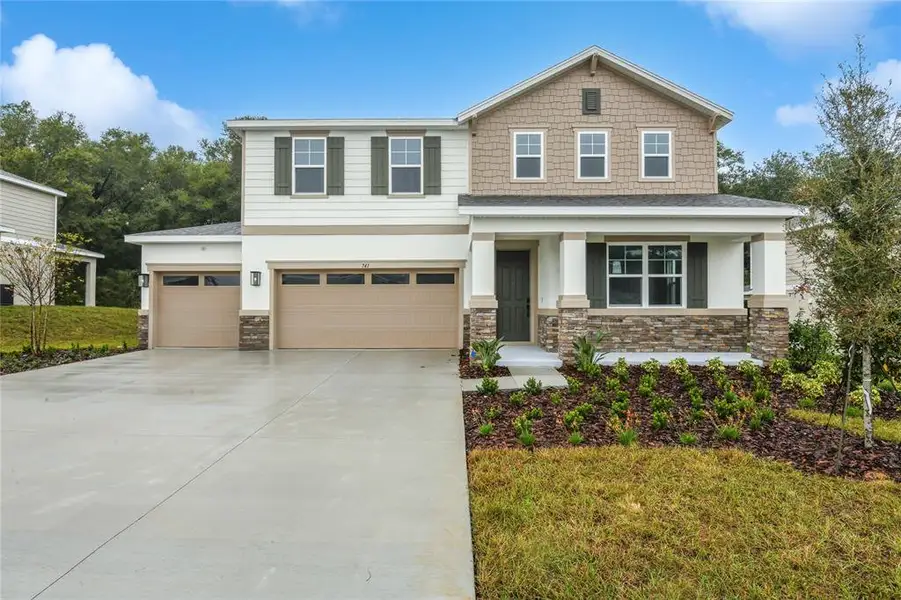 Front exterior of a new home in Seasons at Wekiva Ridge, Mount Dora, FL, highlighting curb appeal (Image 1). Front exterior of a new home in Seasons at Wekiva Ridge, Mount Dora, FL, highlighting curb appeal (Image 1).