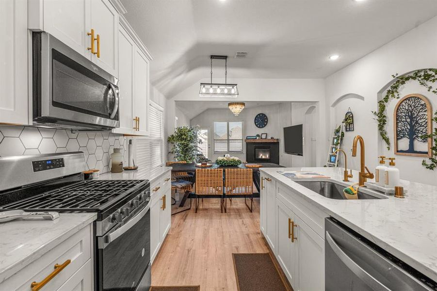 Kitchen with sink, white cabinets, and stainless steel appliances