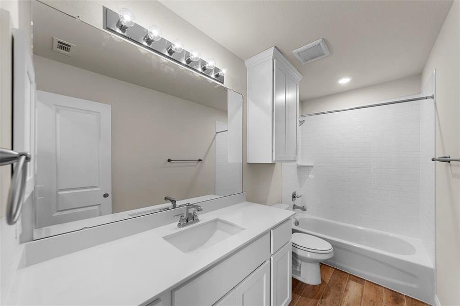 Full bath featuring shower / washtub combination, vanity, light wood-style floors, and recessed lighting