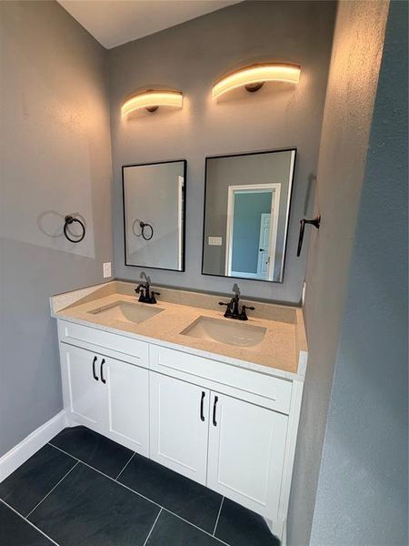 Dual vanity with white cabinetry and black hardware