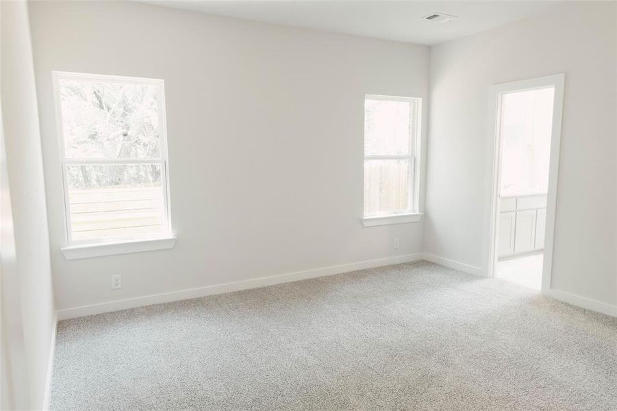 Unfurnished room featuring light carpet