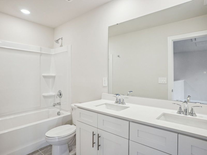 The secondary bathroom boasts dual-sinks and an oversized shower tub.