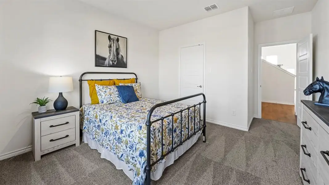 Room featuring light gray carpet, white walls, and a white paneled door