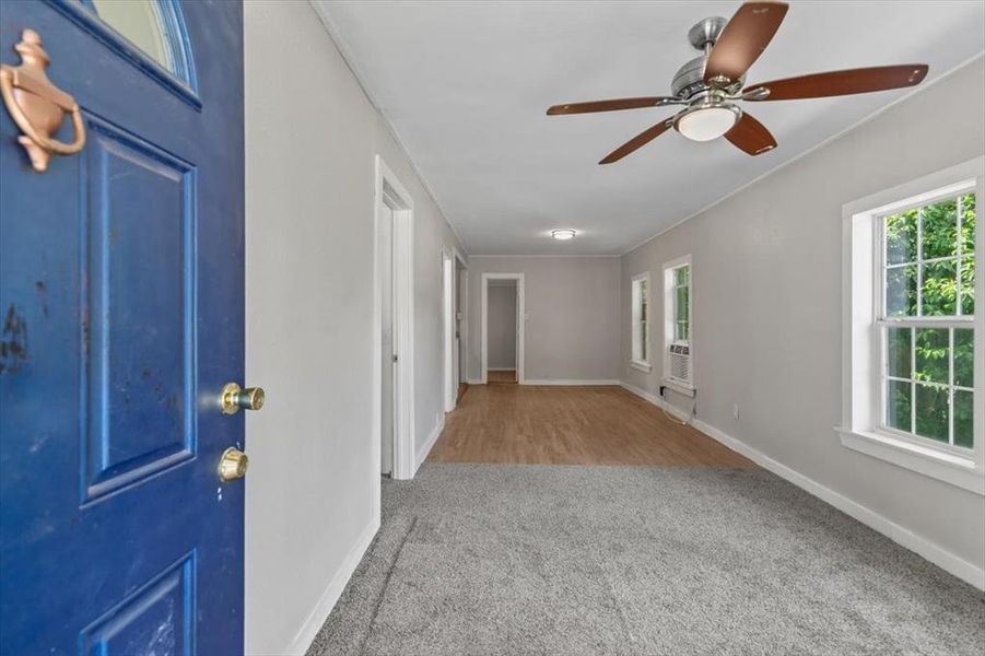 Foyer with ceiling fan, carpet, and ornamental molding Foyer with ceiling fan, carpet, and ornamental molding