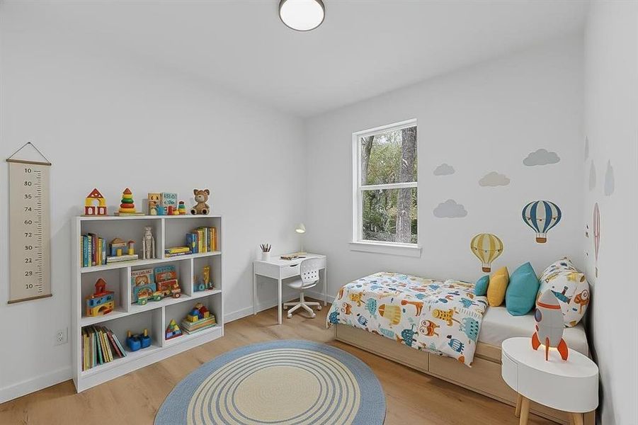 Bedroom featuring light wood-style flooring and baseboards Bedroom featuring light wood-style flooring and baseboards