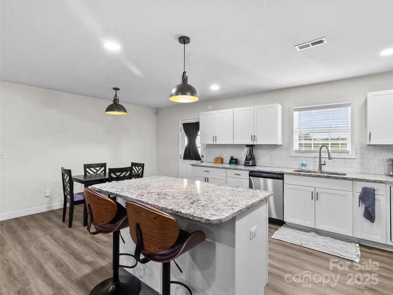 Large Kitchen Island with Beautiful Granite and Stunning Bar Stools (which may convey with an appropriate offer)