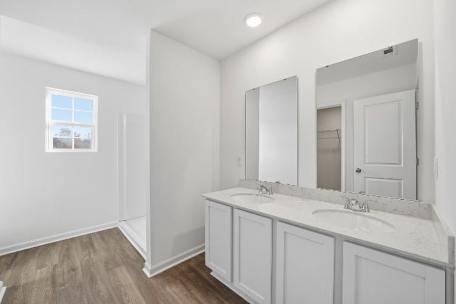 A bathroom with white cabinets. A bathroom with white cabinets.