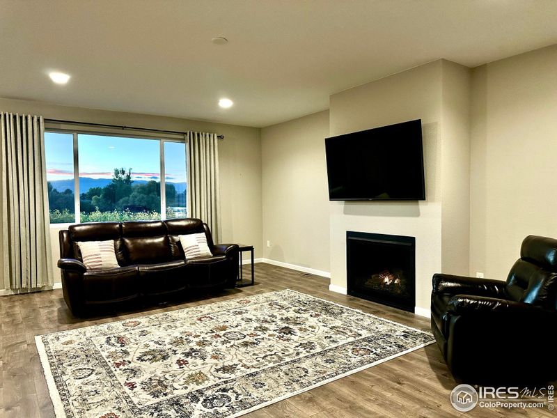 Unobstructed views of the sun setting behind Horsetooth Rock through the living room's picture window