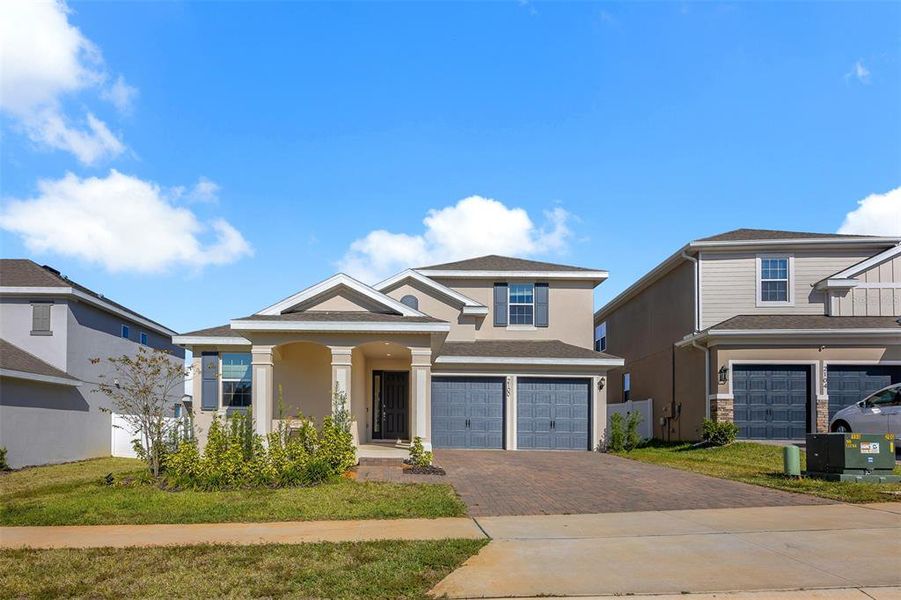Front exterior of a new home in , Minneola, FL, highlighting curb appeal (Image 23). Front exterior of a new home in , Minneola, FL, highlighting curb appeal (Image 23).