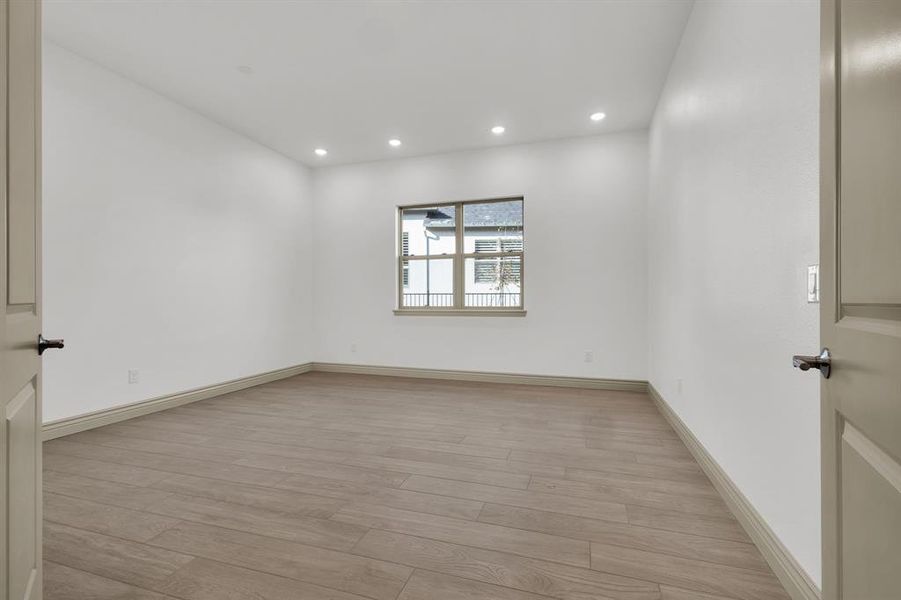 Unfurnished room with light wood-type flooring and recessed lighting