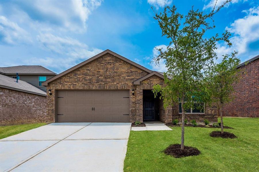 View of front of property with a garage and a front yard