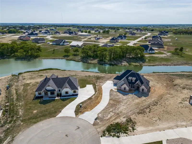 Birds eye view of property with a water view