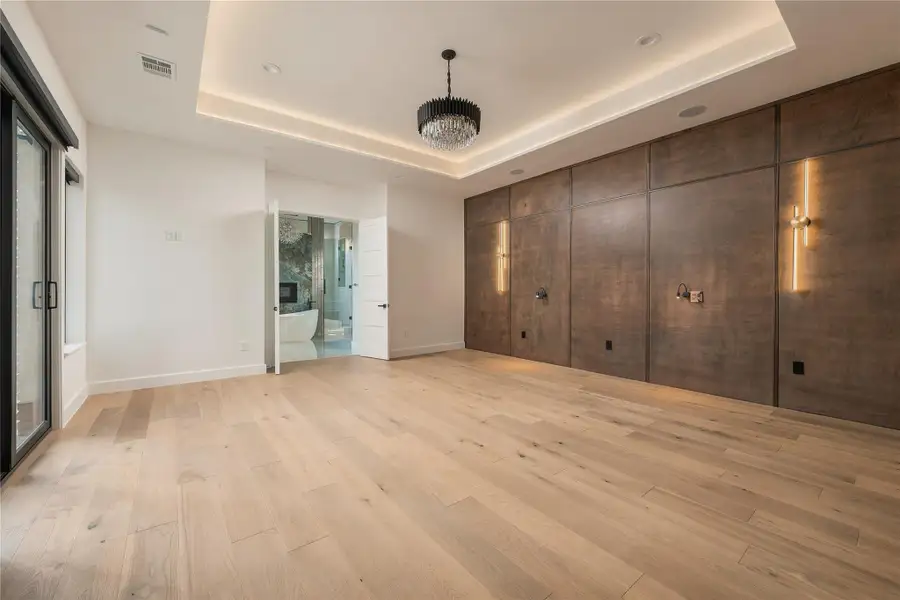 Primary Bedroom with Custom Wood Accents and Lighting