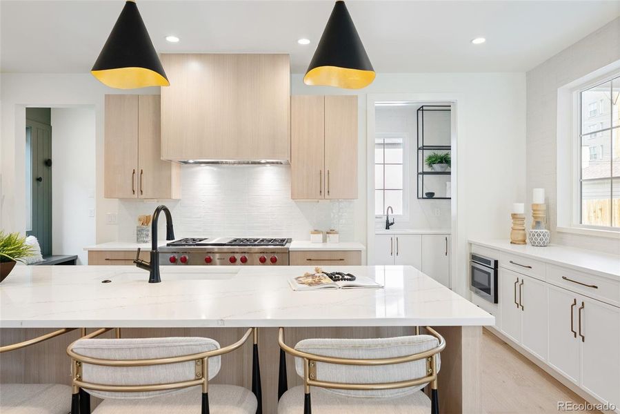 Chef's kitchen delivers long counters, 4-seat island + gorgeous butler's pantry