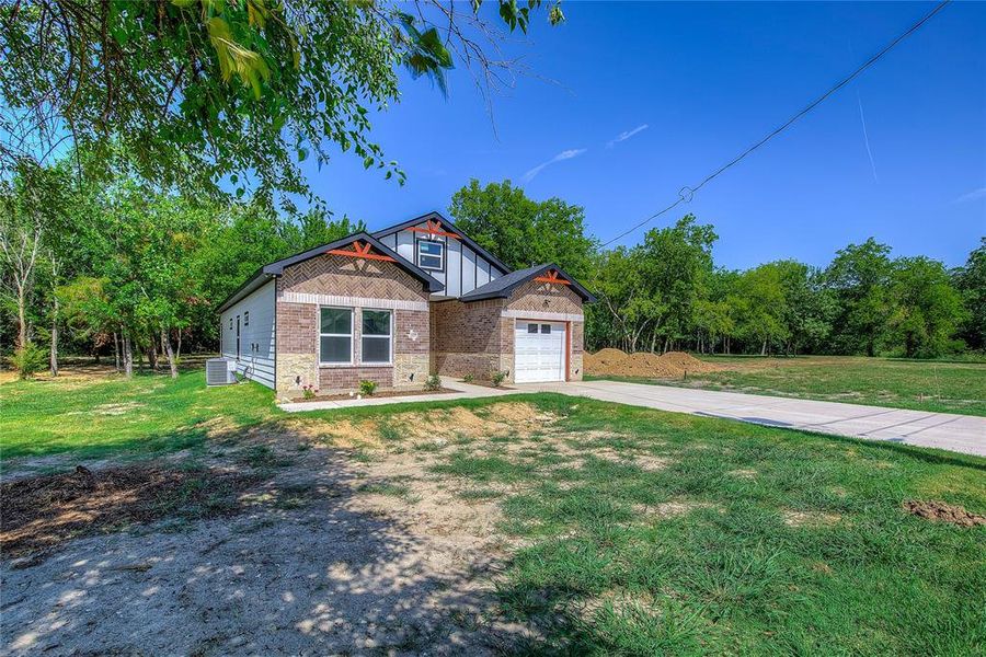 Front exterior of a new home in , Greenville, TX, highlighting curb appeal (Image 22). Front exterior of a new home in , Greenville, TX, highlighting curb appeal (Image 22).