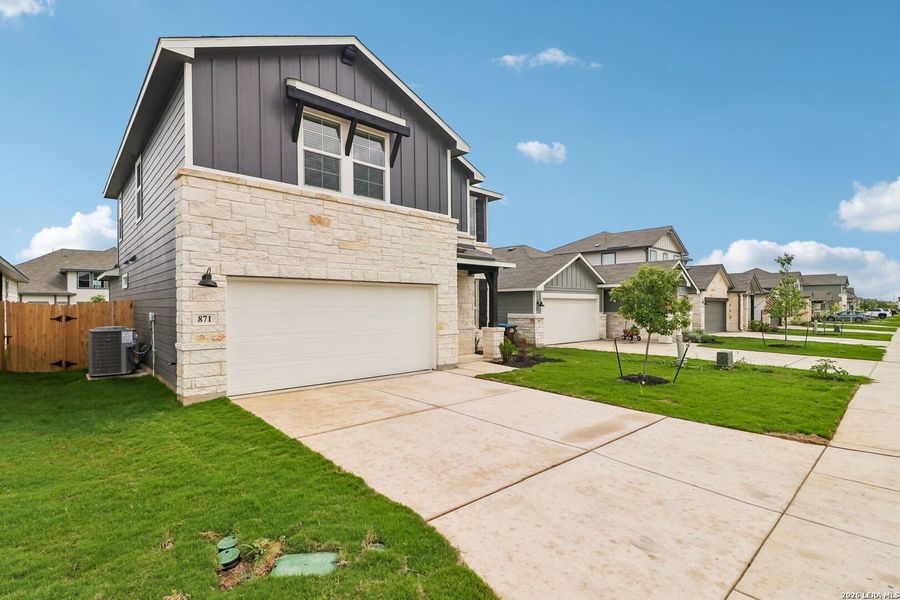 Front exterior of a new home in Estancia Ranch - Premier Series, San Antonio, TX, highlighting curb appeal (Image 21). Front exterior of a new home in Estancia Ranch - Premier Series, San Antonio, TX, highlighting curb appeal (Image 21).