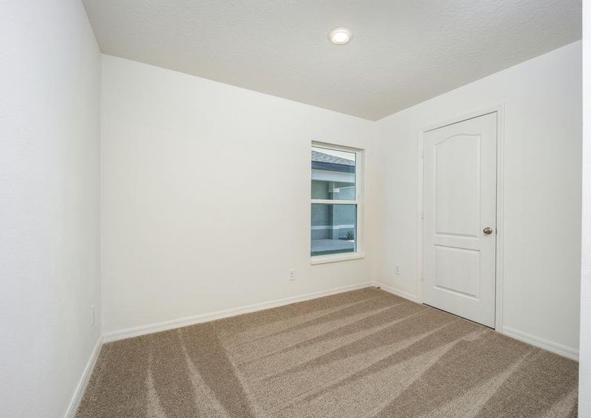 The third bedroom has lush carpet and a spacious closet