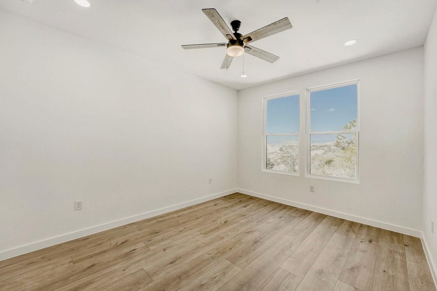 Spare room featuring light wood-style flooring, recessed lighting, and a ceiling fan