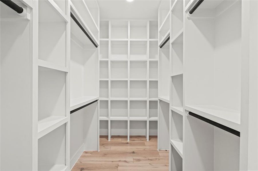 Spacious closet featuring light wood-type flooring