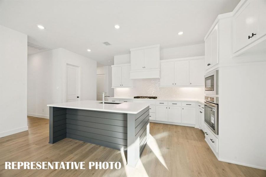 Beautiful cabinetry, gorgeous countertops and striking stainless steel create the kitchen of your dreams!  REPRESENTATIVE PHOTO