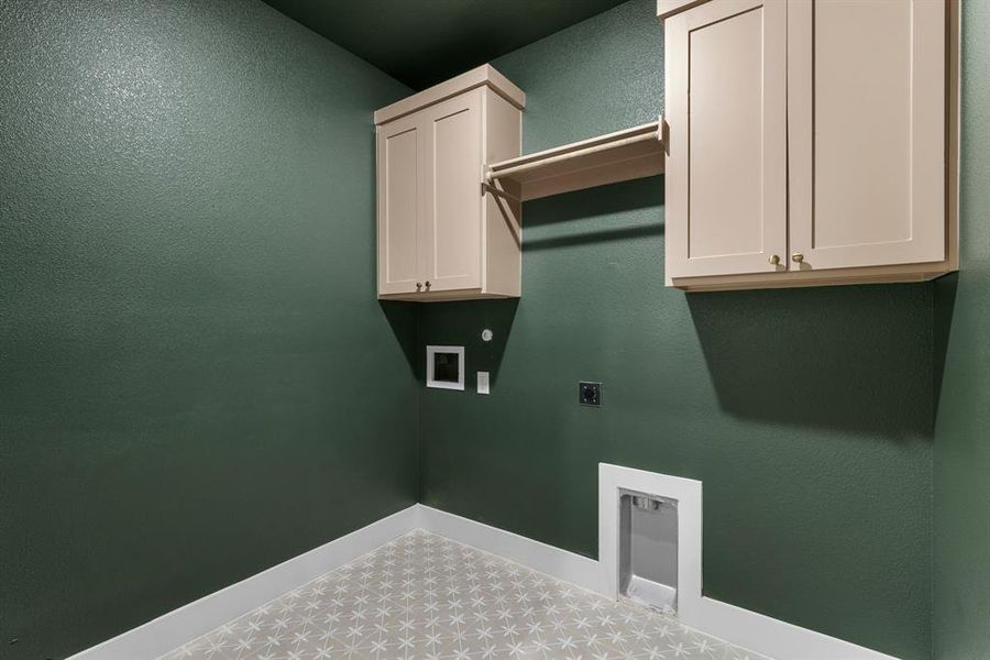 Laundry area featuring cabinets, washer hookup, and electric dryer hookup