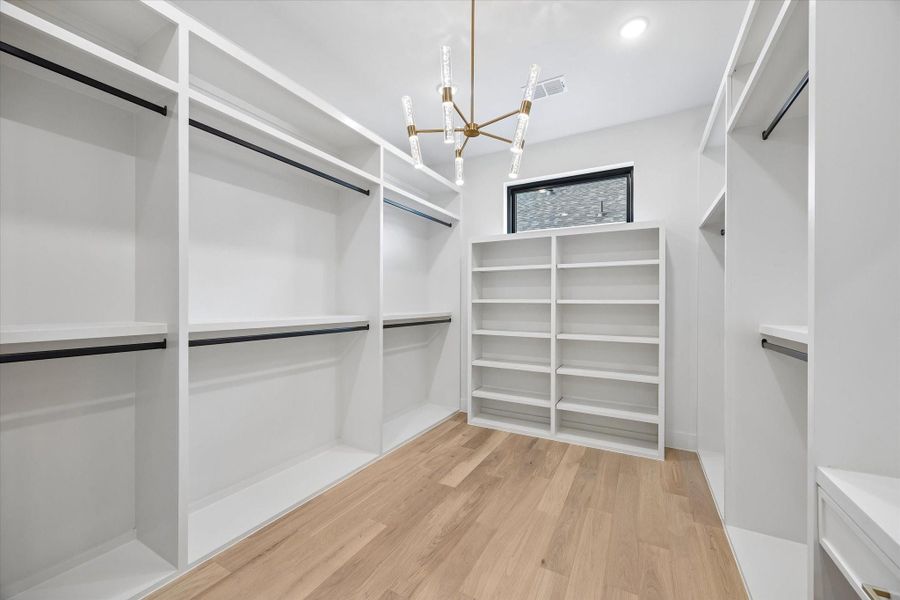 The two separate Primary closets have full custom storage built-ins.