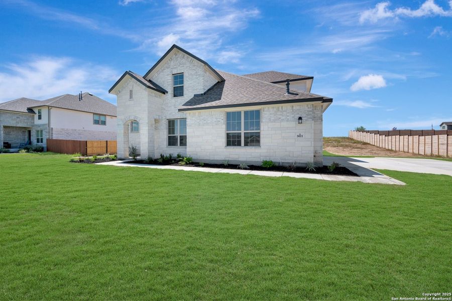 Front exterior of a new home in Everly Estates, San Antonio, TX, highlighting curb appeal (Image 14). Front exterior of a new home in Everly Estates, San Antonio, TX, highlighting curb appeal (Image 14).