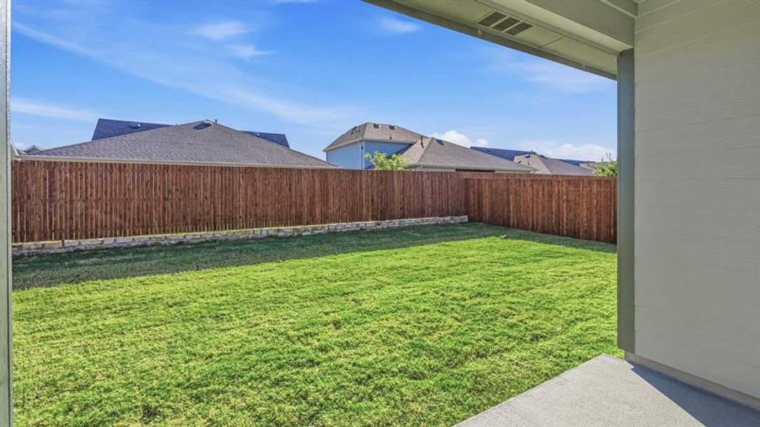 Fenced backyard featuring a patio and a residential view Fenced backyard featuring a patio and a residential view