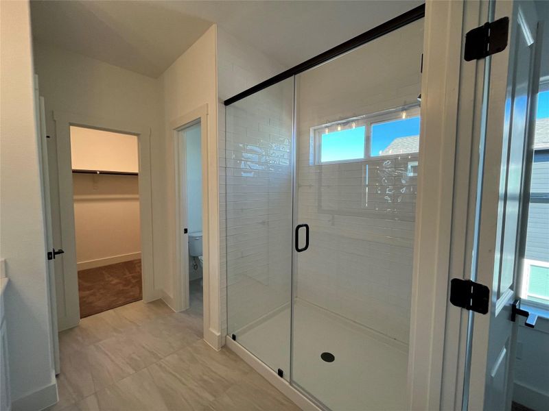 Large walkin shower in master with tile to ceiling and seamless