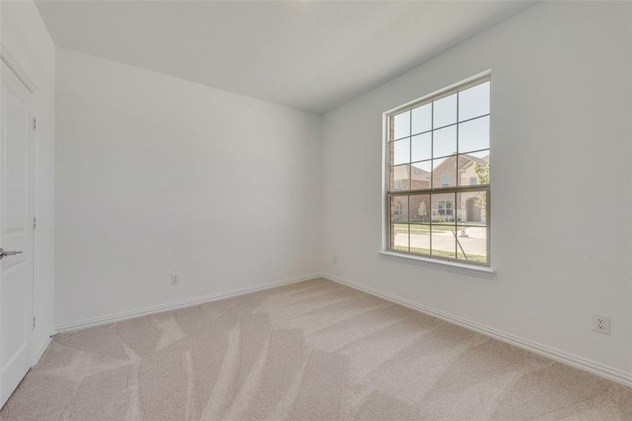 Unfurnished room with light carpet