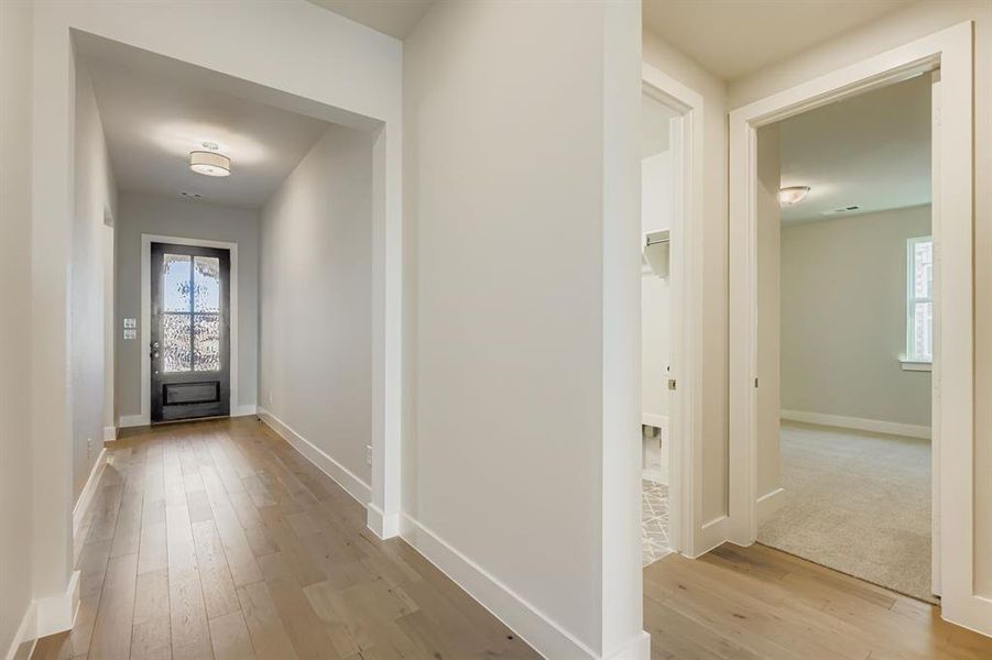 Hallway with light wood finished floors
