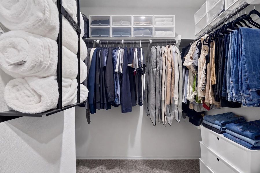 Walk-in primary closet provides generous hanging and storage space to help keep everything organized. Walk-in primary closet provides generous hanging and storage space to help keep everything organized.