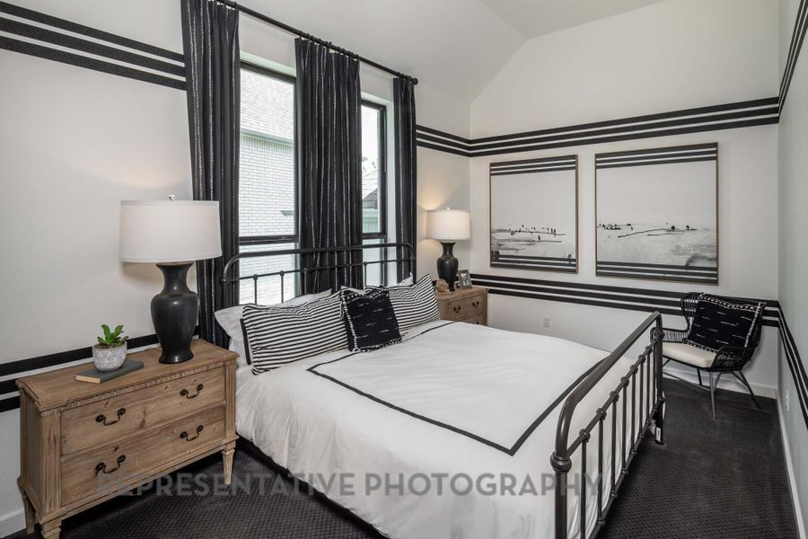 Bedroom with vaulted ceiling and baseboards Bedroom with vaulted ceiling and baseboards