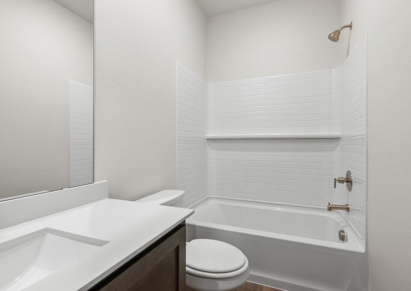 The secondary bathroom has a shower-tub combo.
