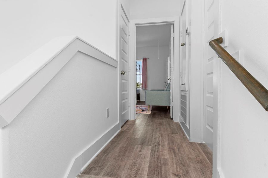 Well-lit hallway offering easy access to bedrooms and baths.