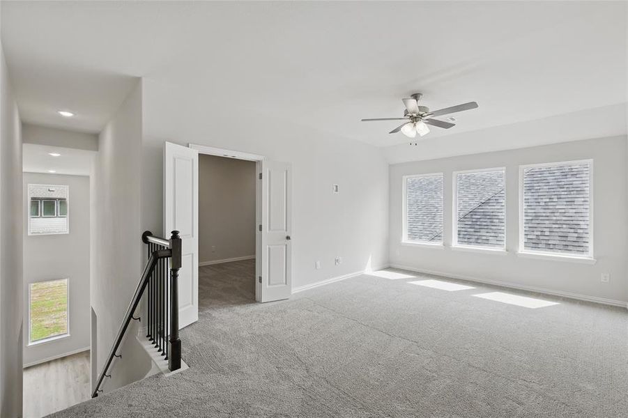Carpeted spare room with baseboards, recessed lighting, and a ceiling fan Carpeted spare room with baseboards, recessed lighting, and a ceiling fan