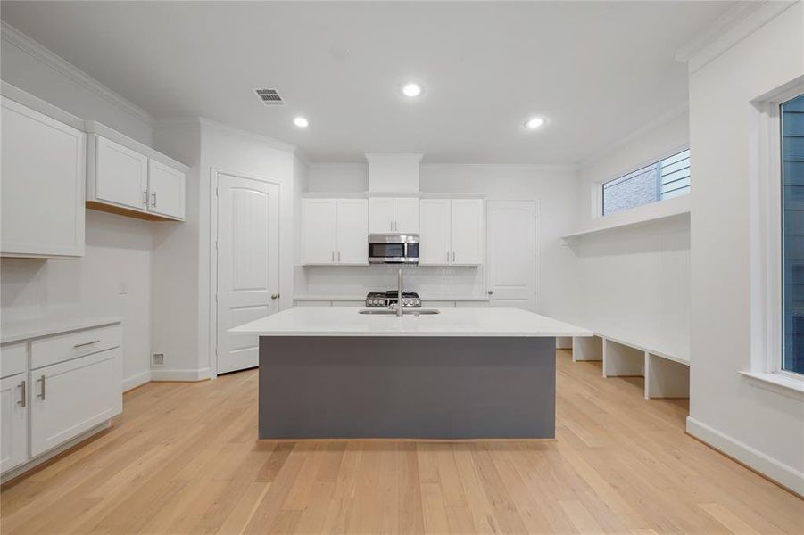 The Chesapeake Kitchen! Featuring quartz countertops, Benedettini custom cabinets, including a pull-out trash can for added convivence and Moen plumbing fixtures. (Sample photos of a completed Chesapeake floor plan. The image may feature alternative selections and/or upgrades.)