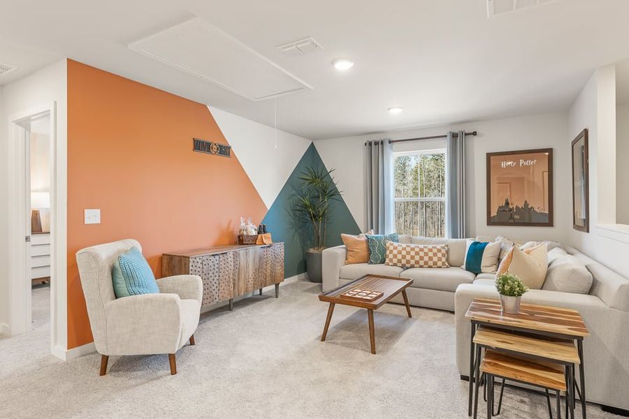 A living room with a couch and a table. A living room with a couch and a table.