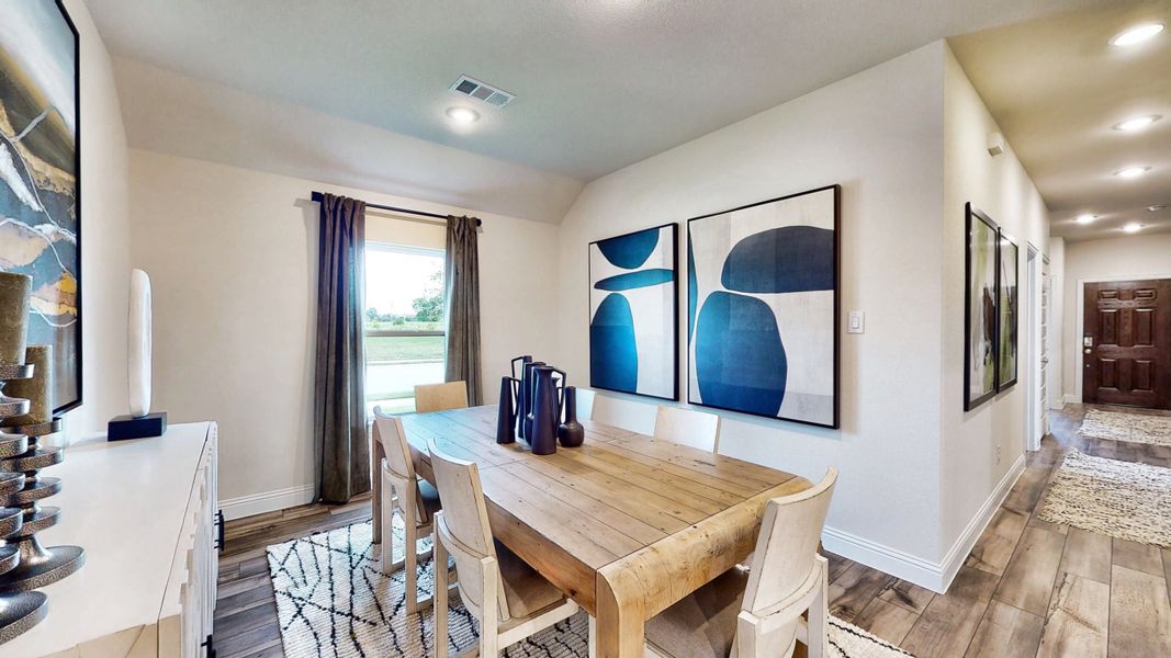 A dining room with a table and chairs. A dining room with a table and chairs.