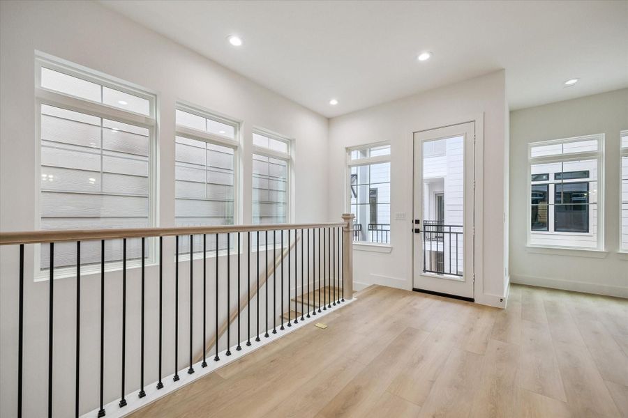 Airy upstairs landing offering flexible use and generous window light