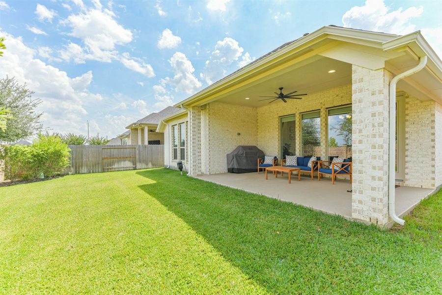 Extended covered back porch has gas stub, TV outlet, fan, and full gutters. Extended covered back porch has gas stub, TV outlet, fan, and full gutters.