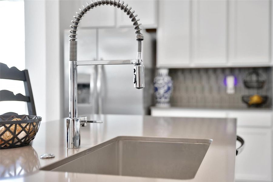 neutral tones and stylish hardware grace the kitchen